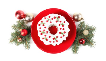 Photo of Beautifully decorated Christmas cake, fir branches and baubles on white background, top view