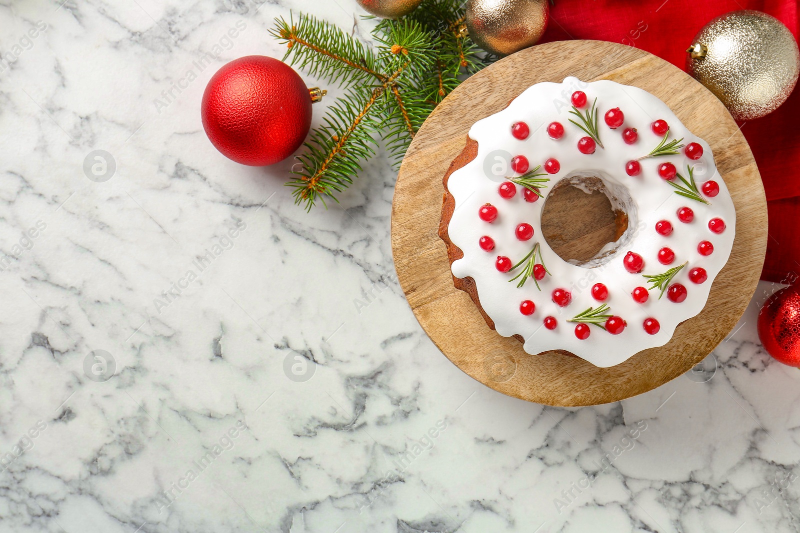 Photo of Beautifully decorated Christmas cake and decor on white marble table, flat lay. Space for text