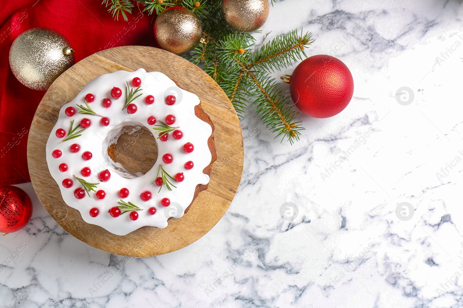 Photo of Beautifully decorated Christmas cake and decor on white marble table, flat lay. Space for text