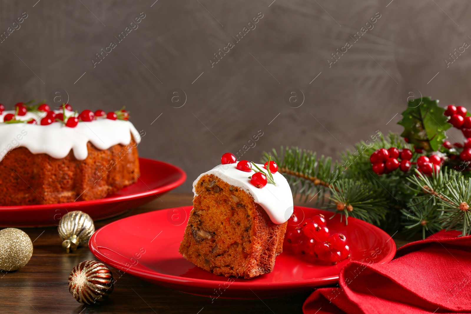 Photo of Piece of traditional classic Christmas cake and decor on wooden table