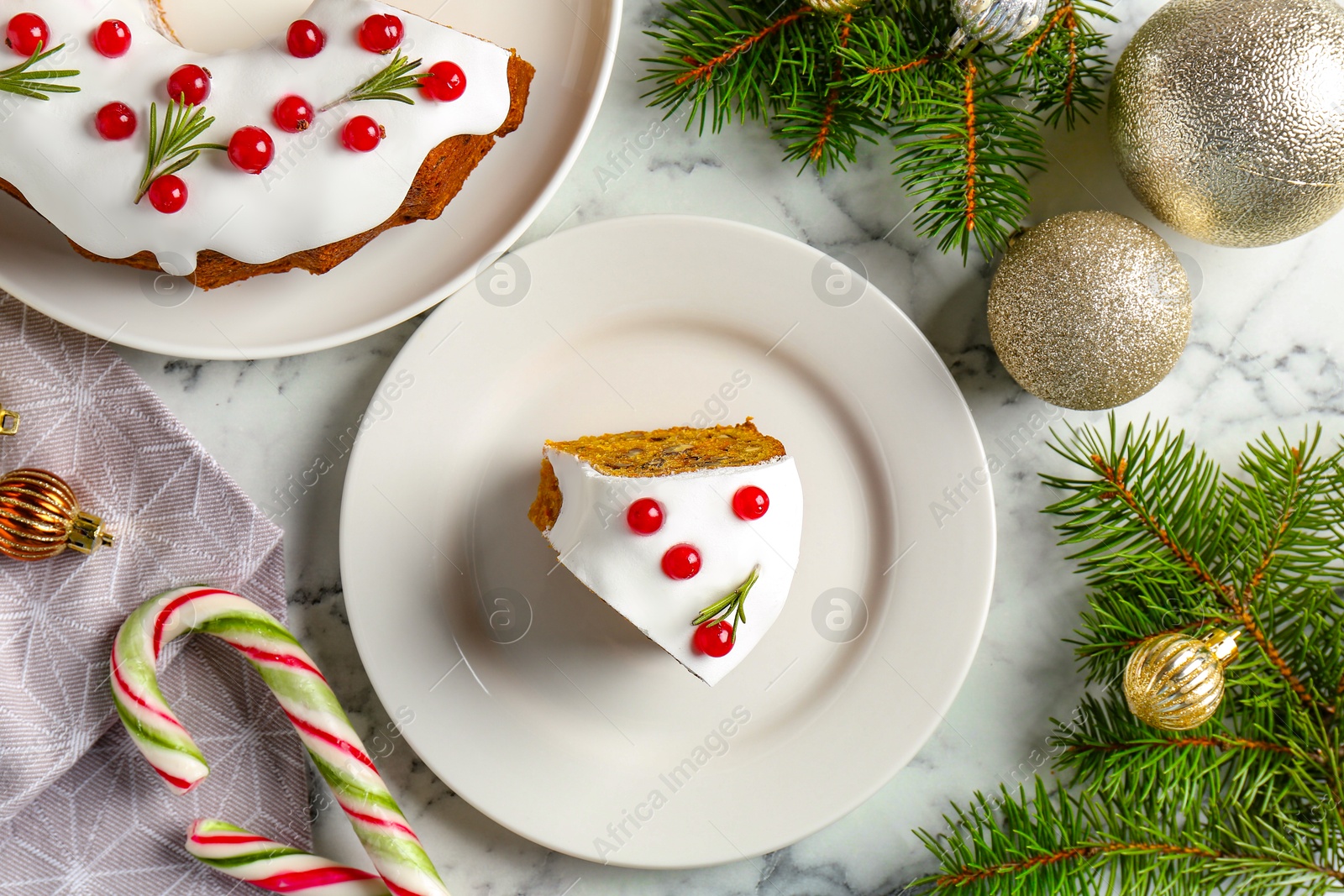 Photo of Traditional classic Christmas cake and decor on white marble table, flat lay