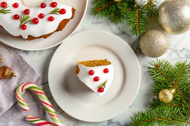 Photo of Traditional classic Christmas cake and decor on white marble table, flat lay