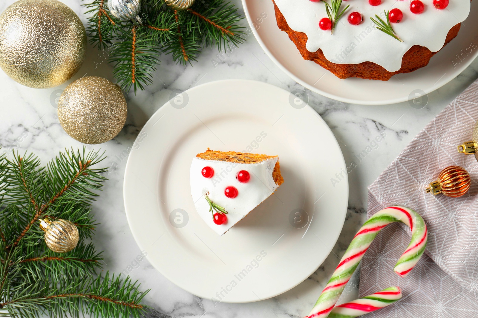 Photo of Traditional classic Christmas cake and decor on white marble table, flat lay