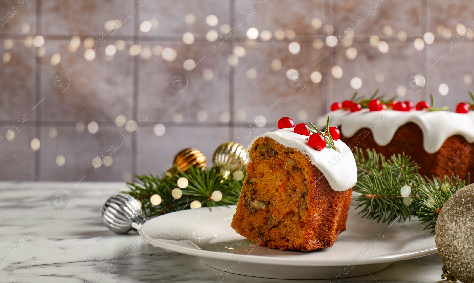 Photo of Piece of traditional classic Christmas cake and decor on white marble table, space for text