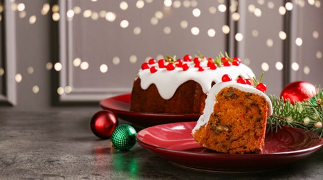 Photo of Traditional classic Christmas cake and decor on gray textured table, space for text