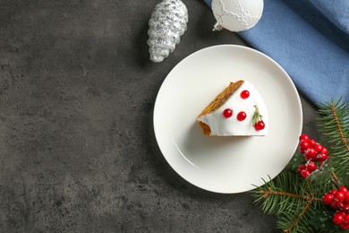 Photo of Piece of traditional classic Christmas cake and decor on gray textured table, flat lay. Space for text