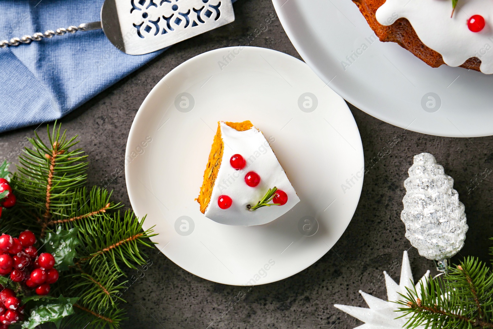 Photo of Traditional classic Christmas cake, decor and cake server on gray textured table, flat lay