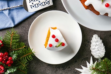 Photo of Traditional classic Christmas cake, decor and cake server on gray textured table, flat lay