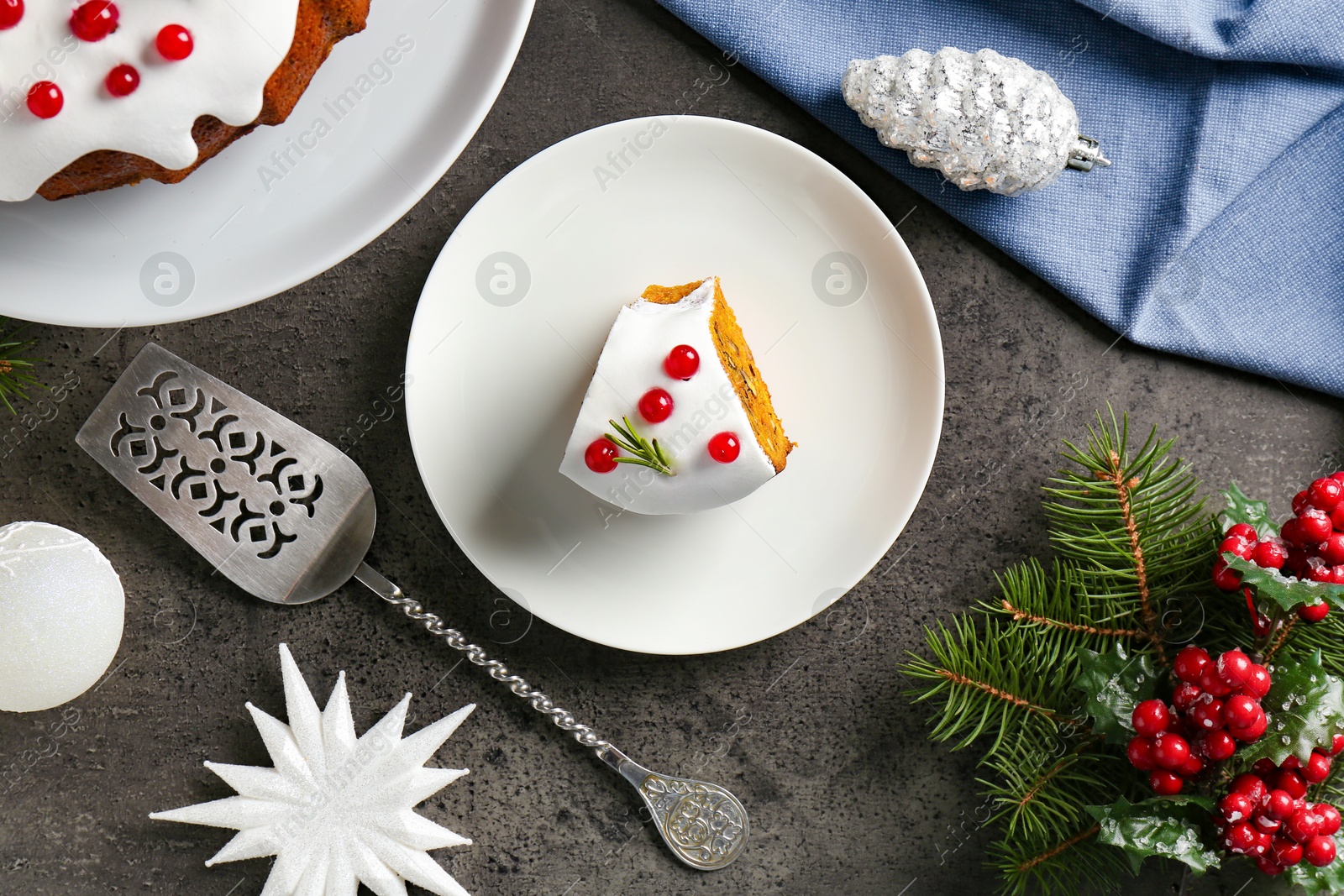 Photo of Traditional classic Christmas cake, decor and cake server on gray textured table, flat lay