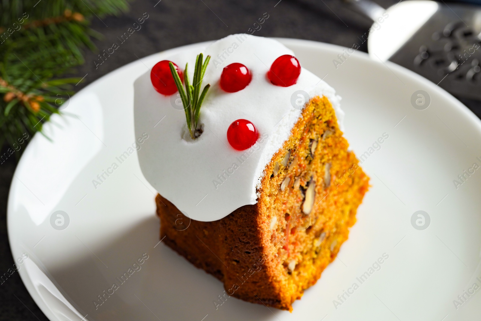 Photo of Piece of traditional classic Christmas cake on gray table, closeup