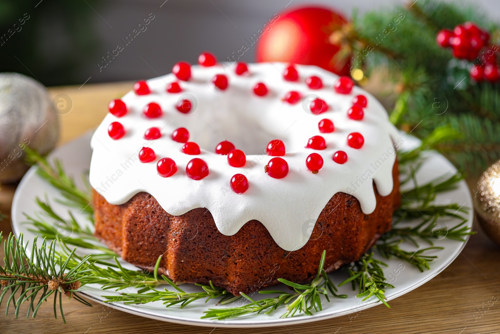 Photo of Traditional classic Christmas cake and decor on wooden table, closeup