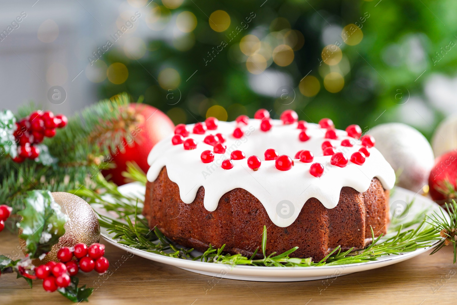 Photo of Traditional classic Christmas cake and decor on wooden table, closeup