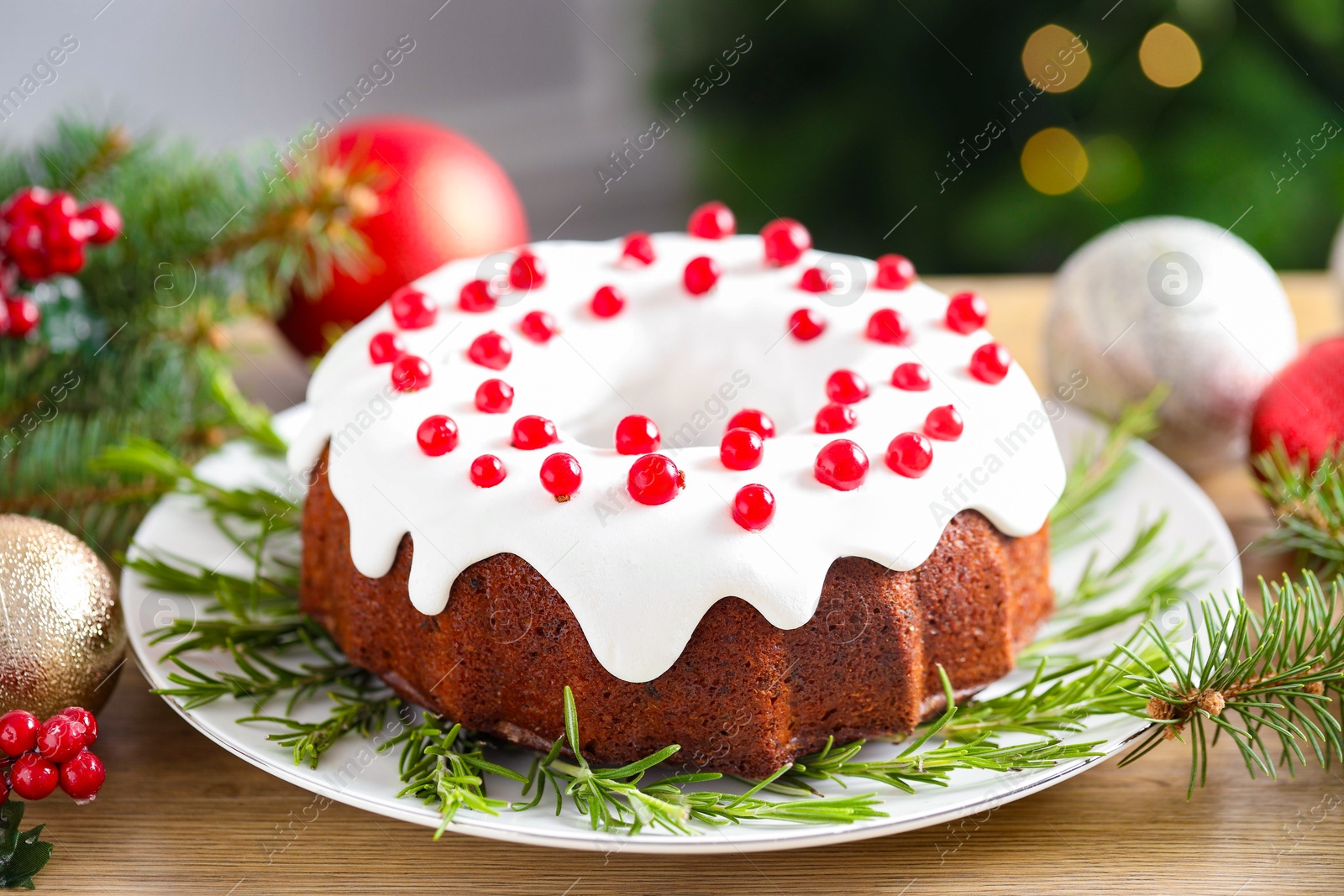 Photo of Traditional classic Christmas cake and decor on wooden table, closeup