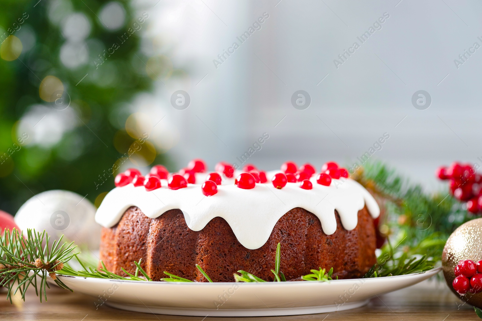 Photo of Traditional classic Christmas cake and decor on wooden table, closeup