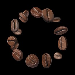 Image of Aromatic roasted coffee beans whirling in air on black background