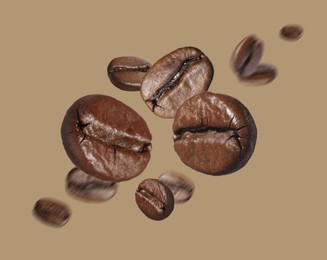 Image of Aromatic roasted coffee beans in air on dark beige background