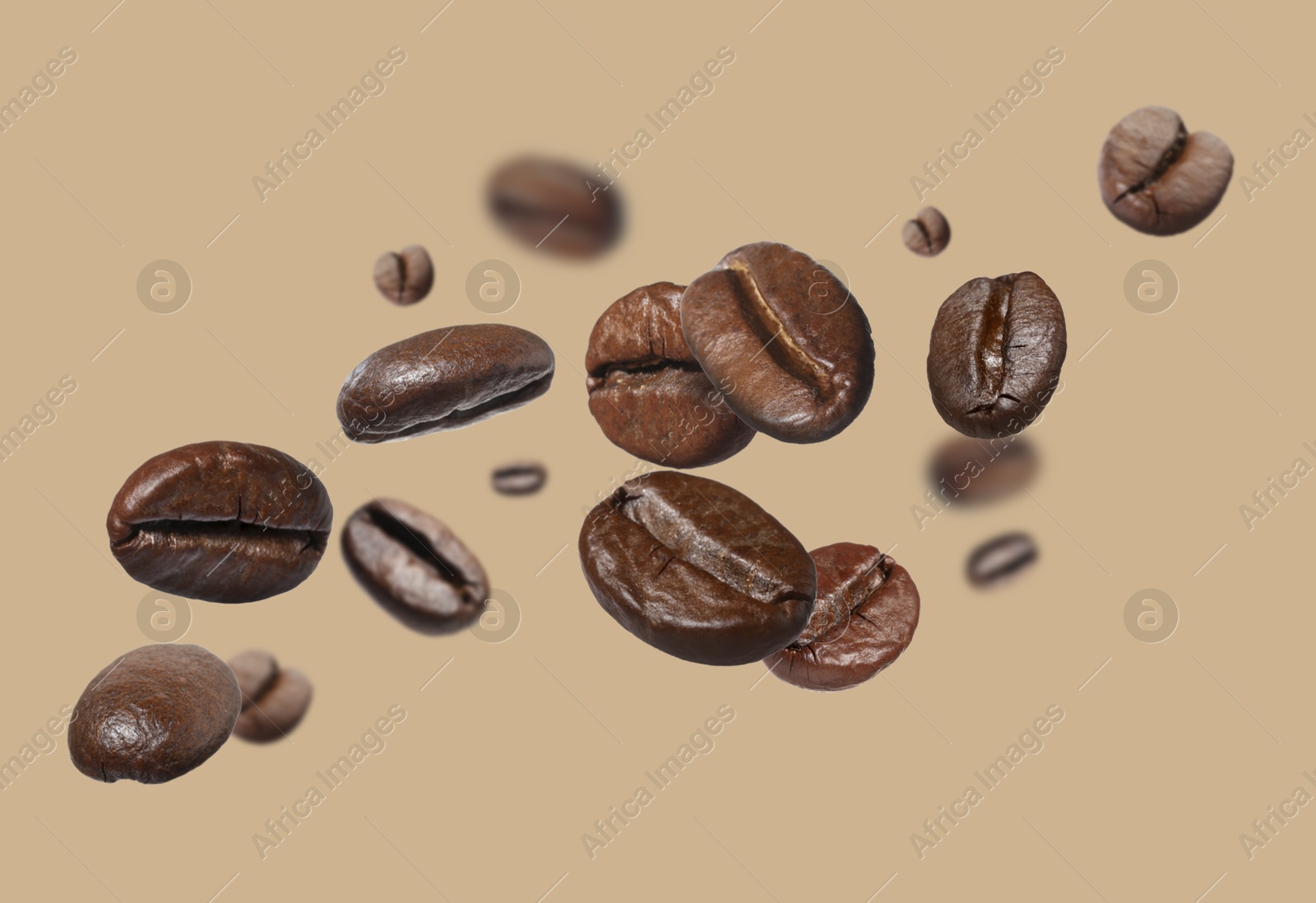 Image of Aromatic roasted coffee beans in air on beige background