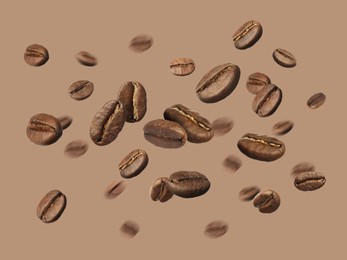 Image of Aromatic roasted coffee beans in air on dark beige background