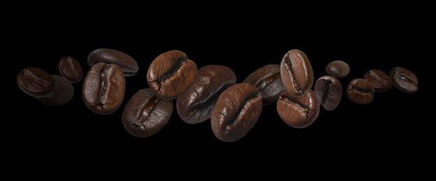 Image of Aromatic roasted coffee beans in air on black background. Banner design