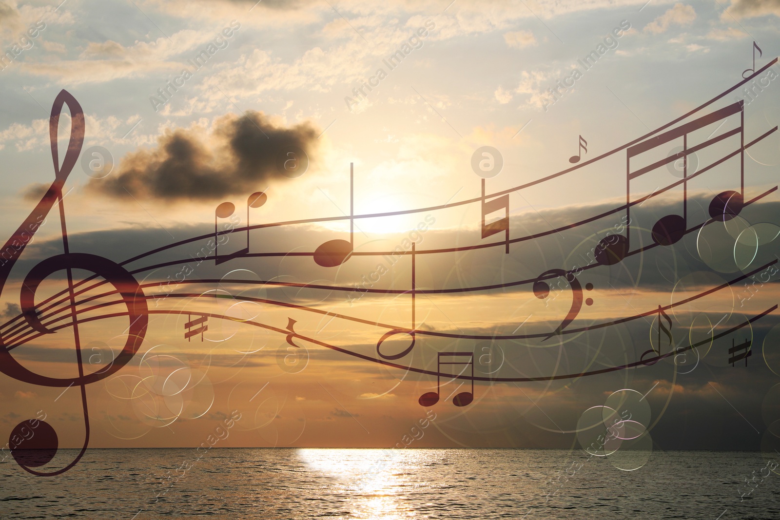 Image of Musical symbols in beautiful sky with clouds over sea at sunset