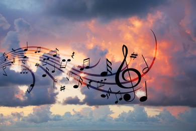 Image of Musical symbols in beautiful sunset sky with clouds