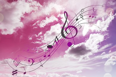 Image of Musical symbols in beautiful sky with clouds, color toned