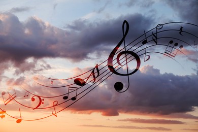 Image of Musical symbols in beautiful sunset sky with clouds