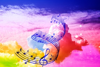 Image of Musical symbols in beautiful sky with clouds, color toned