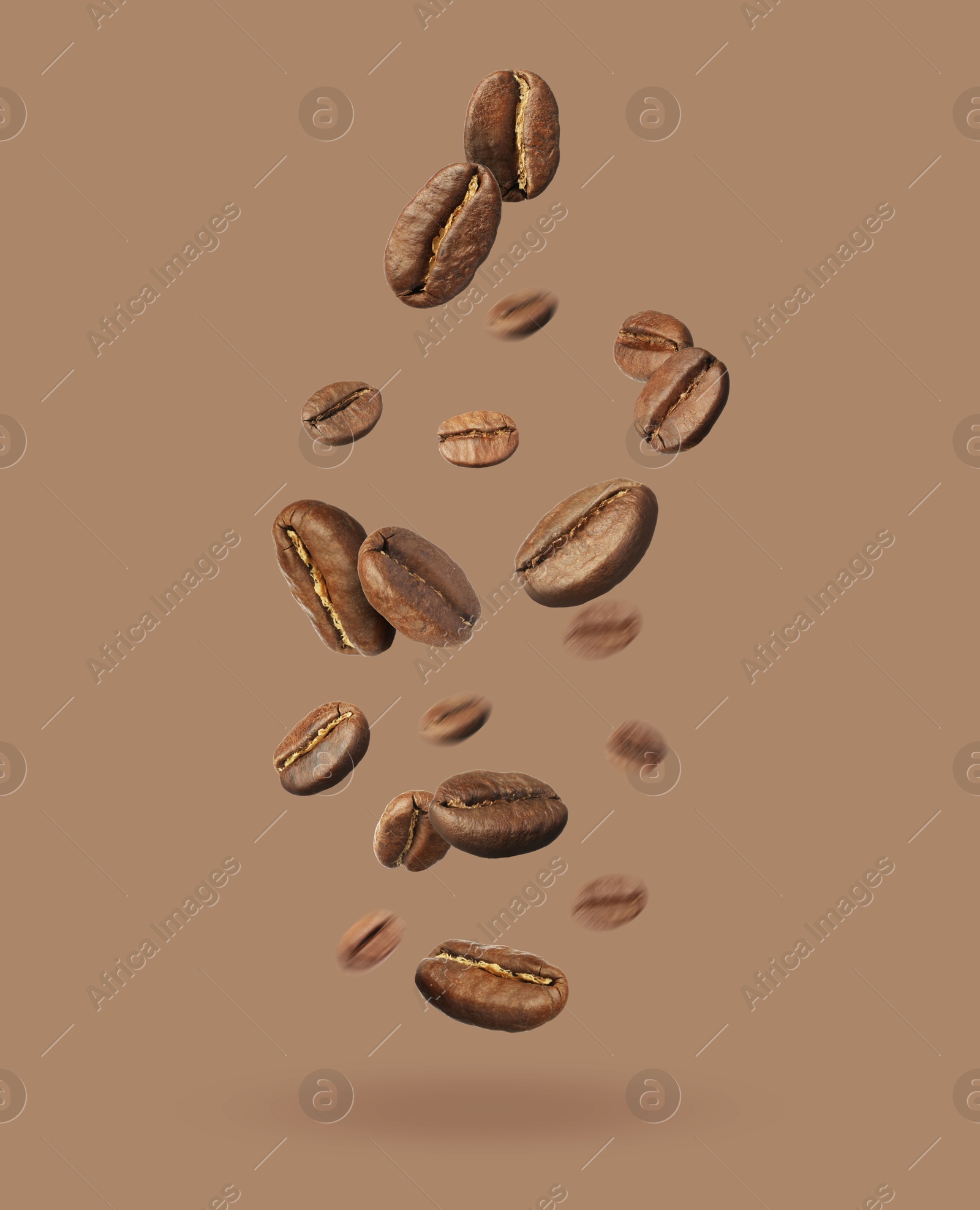 Image of Aromatic roasted coffee beans falling on dark beige background