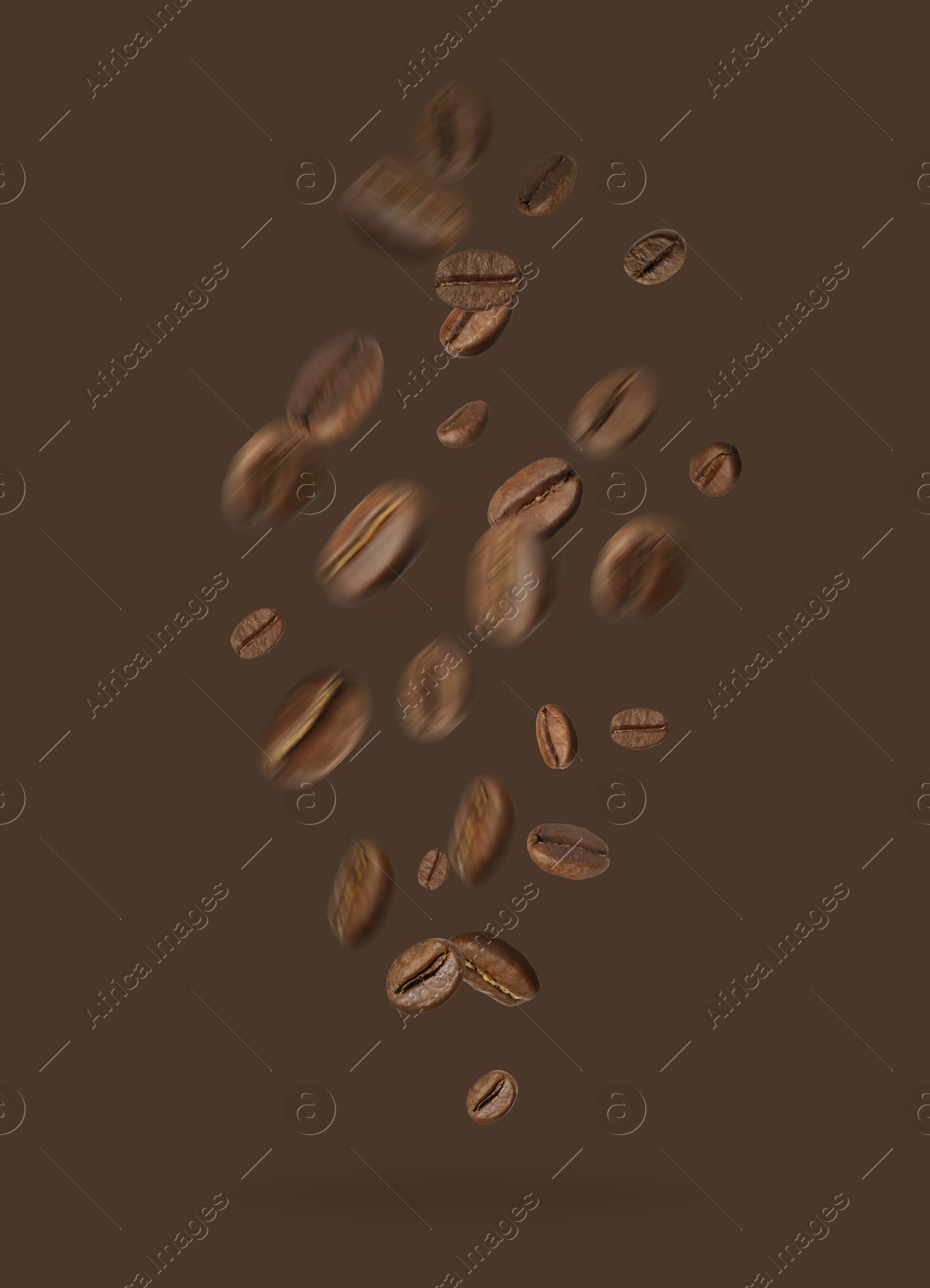 Image of Aromatic roasted coffee beans falling on brown background