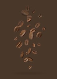 Image of Aromatic roasted coffee beans falling on brown background