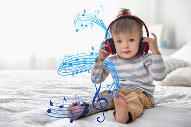 Image of Cute little baby with headphones on bed at home, space for text. Music notes flying around