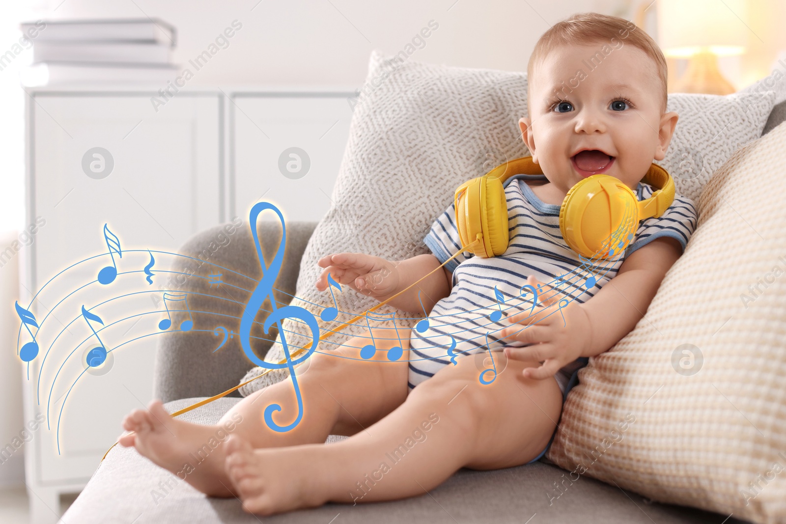 Image of Cute little baby with headphones on sofa at home. Music notes flying around