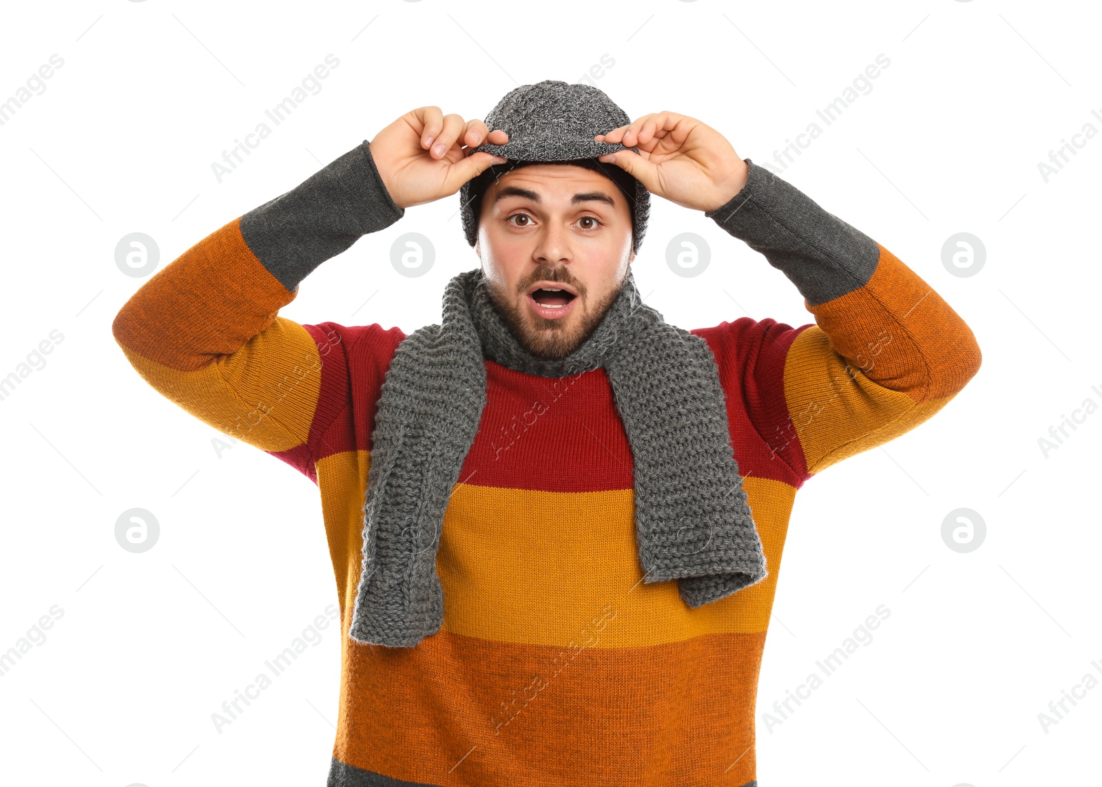 Photo of Emotional young man in warm clothes on white background. Winter vacation