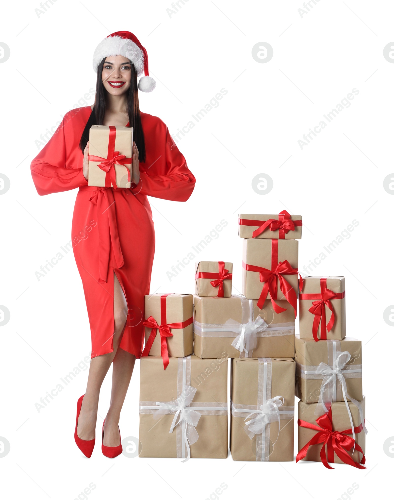 Photo of Woman in red dress and Santa hat with Christmas gifts on white background