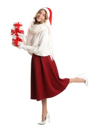 Beautiful young woman in Santa hat with Christmas presents on white background