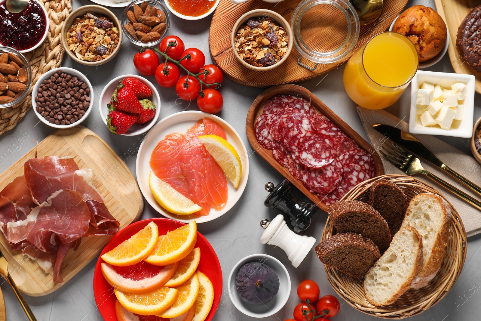 Photo of Different tasty food served for brunch on grey table, flat lay