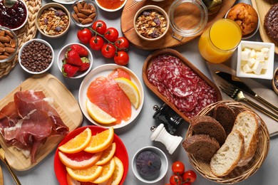 Photo of Different tasty food served for brunch on grey table, flat lay