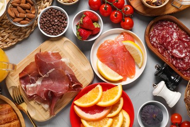 Photo of Different tasty food served for brunch on grey table, flat lay