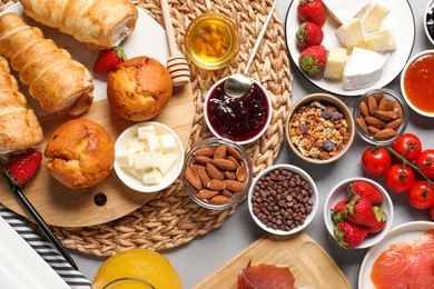 Photo of Different tasty food served for brunch on grey table, flat lay