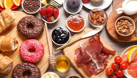 Photo of Different tasty food served for brunch on wooden table, flat lay