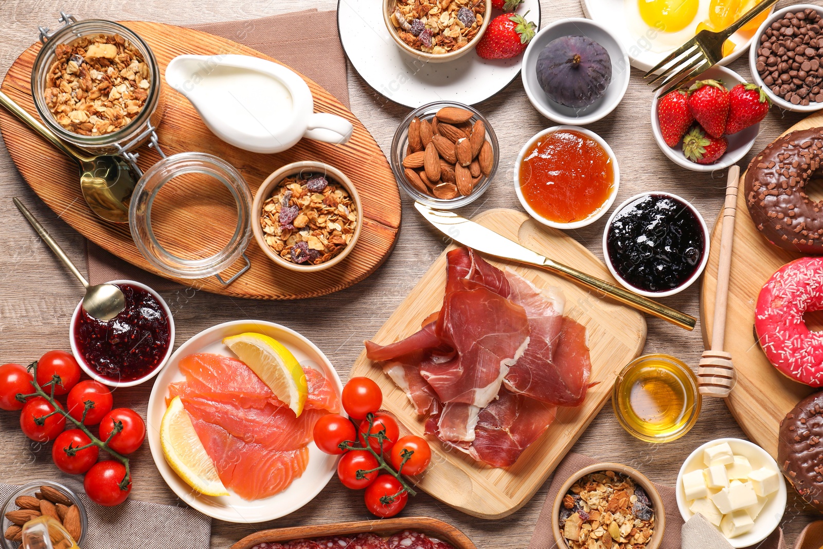 Photo of Different tasty food served for brunch on wooden table, flat lay