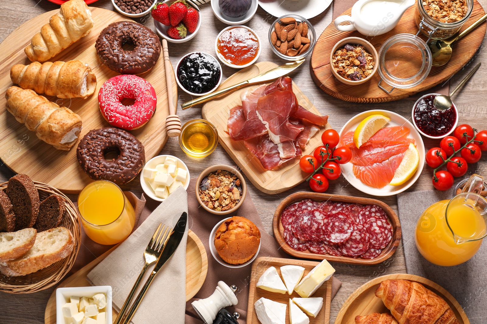 Photo of Different tasty food served for brunch on wooden table, flat lay