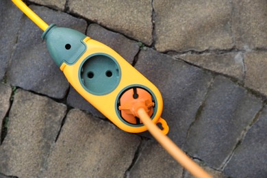 Photo of Extension cord on paved pathway outdoors, top view