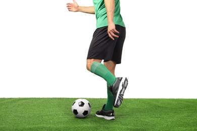 Man playing football with soccer ball on artificial grass against white background, closeup