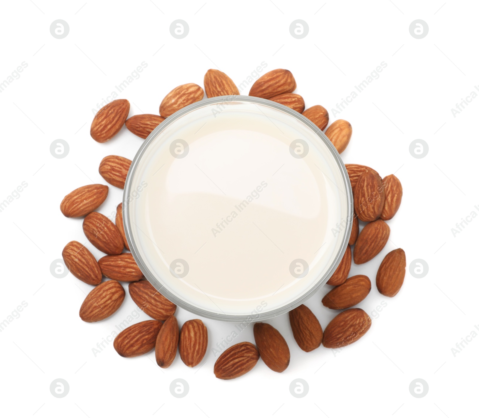 Photo of Glass of almond milk and nuts isolated on white, top view