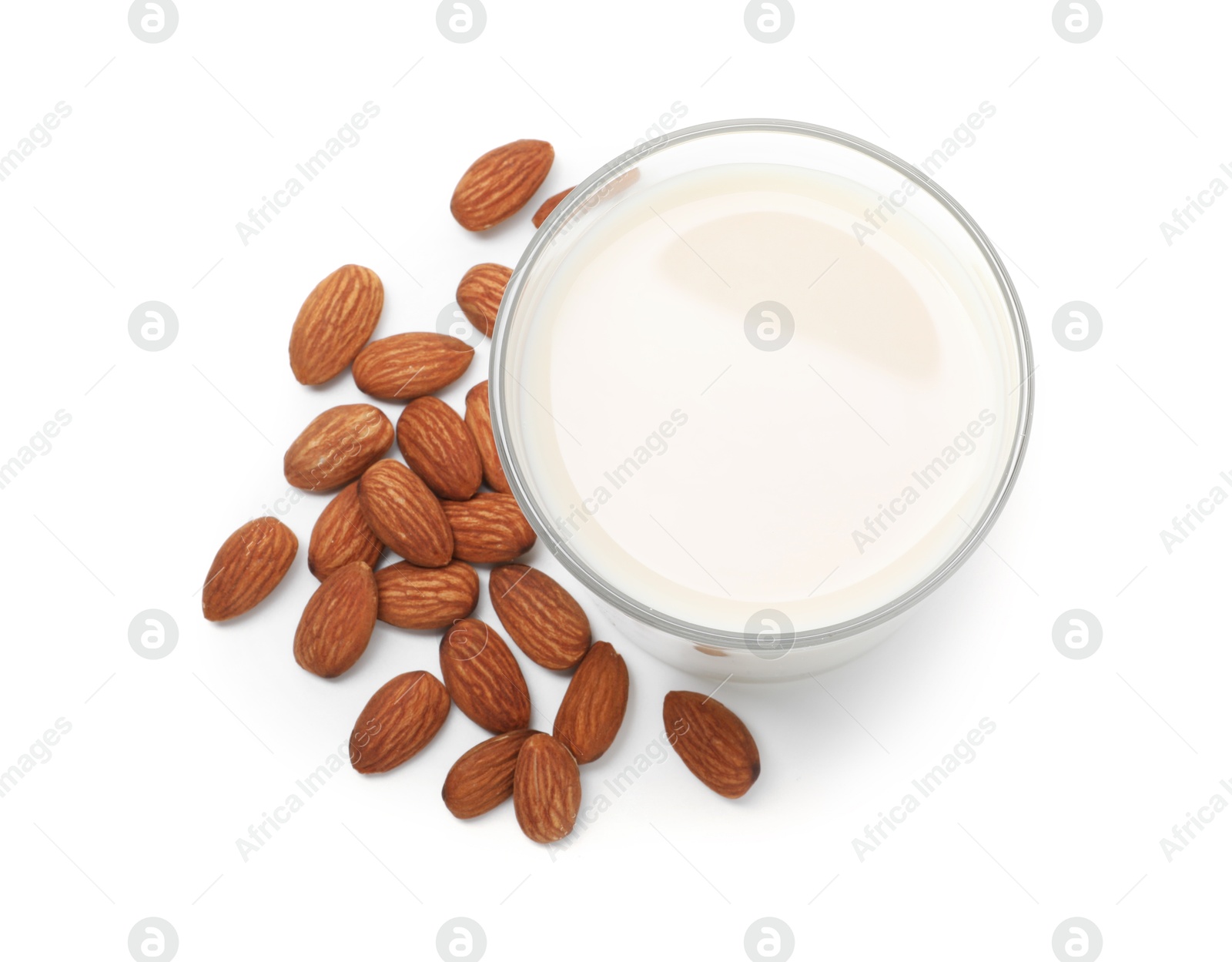 Photo of Glass of almond milk and nuts isolated on white, top view