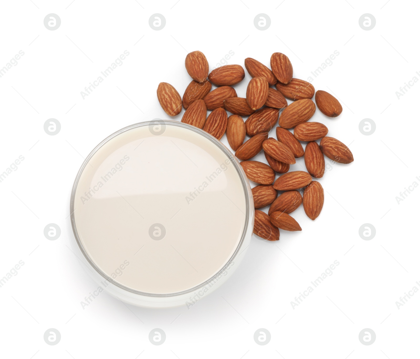 Photo of Glass of almond milk and nuts isolated on white, top view