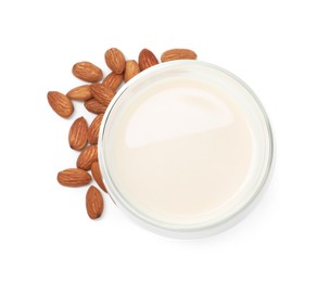 Glass of almond milk and nuts isolated on white, top view