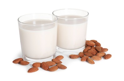 Glasses of almond milk and nuts isolated on white